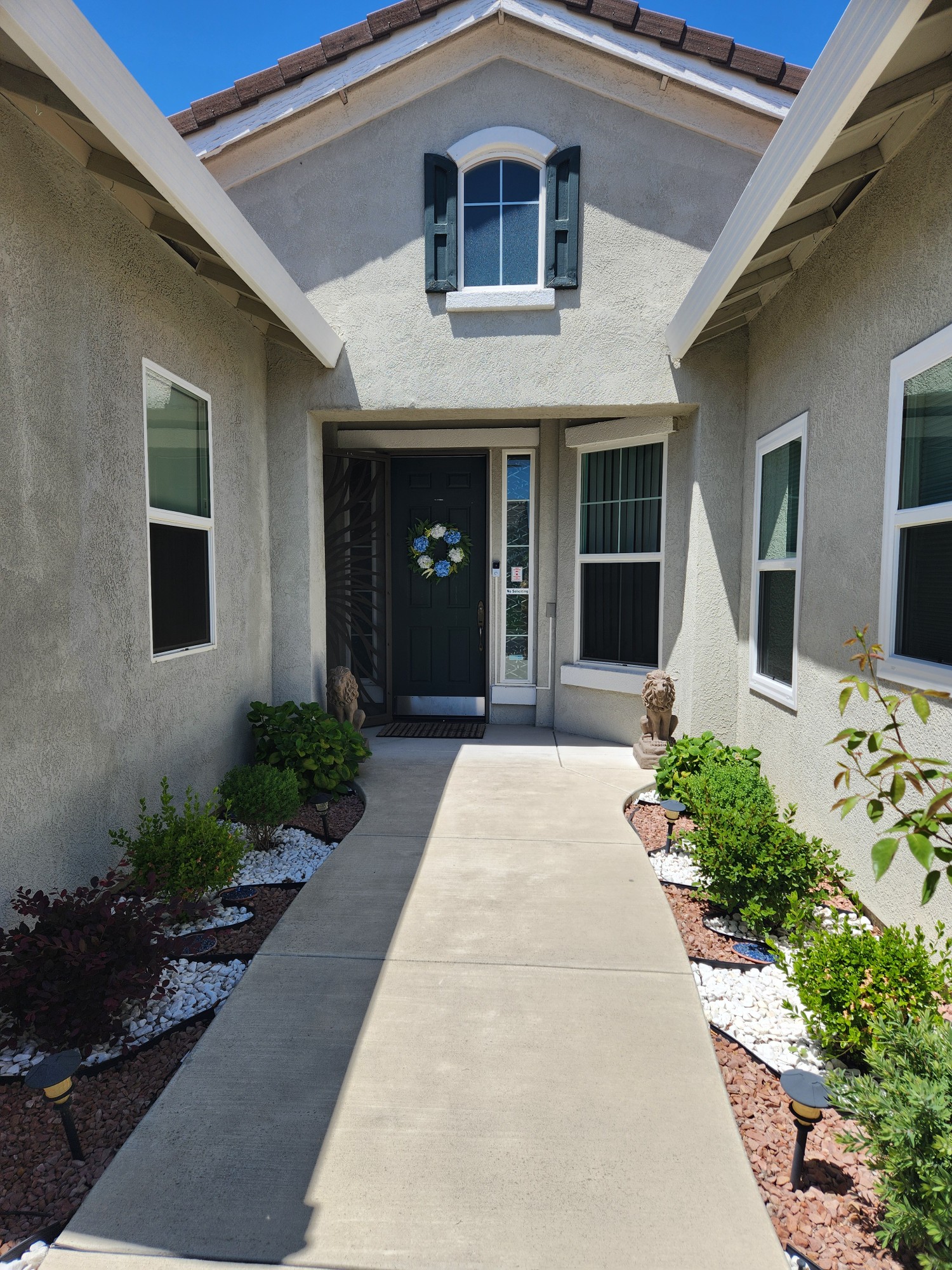 Exterior of Heavenly Angels assisted living home in Roseville, California with garden and warm afternoon light